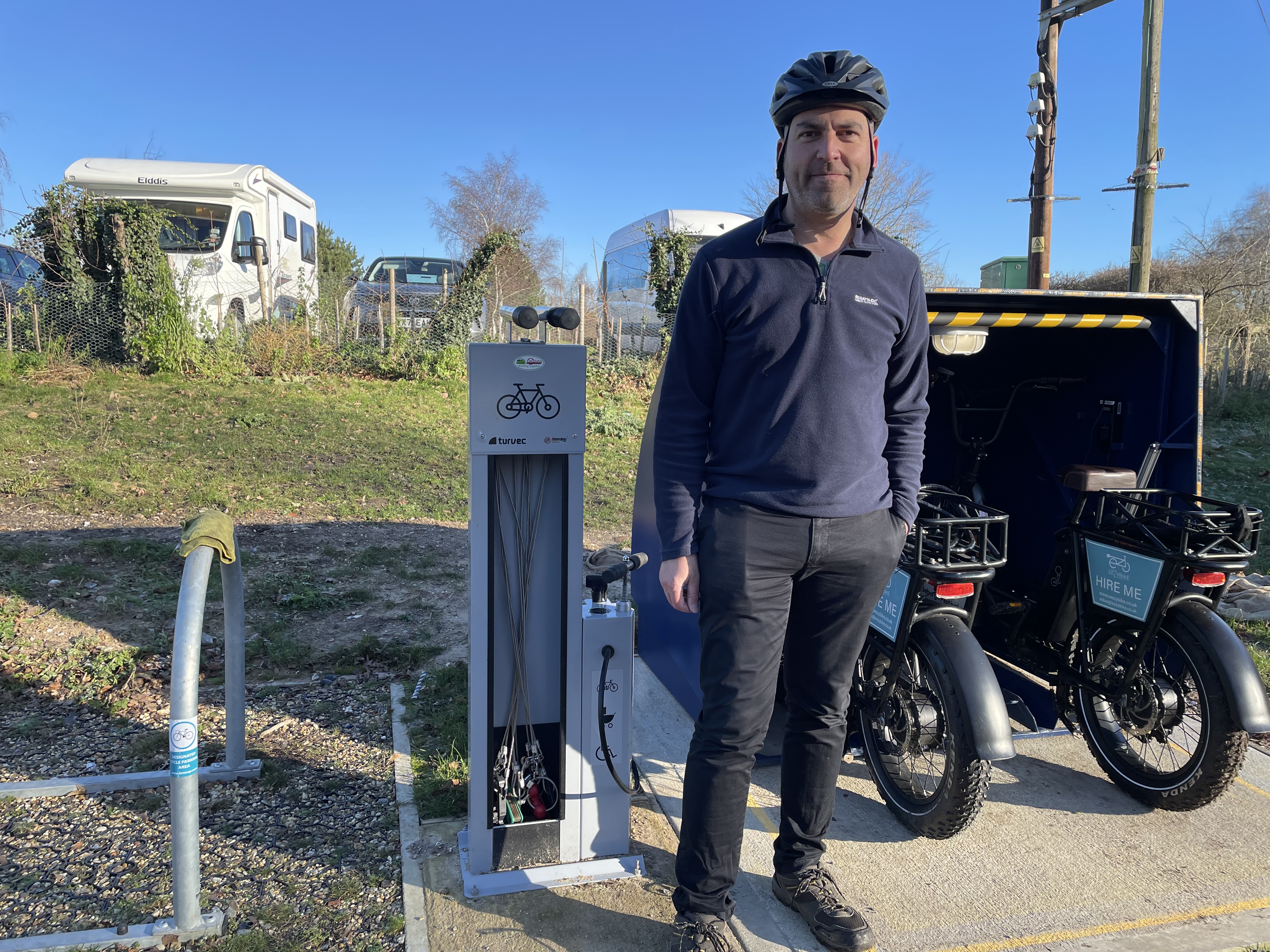 Cllr Tim Weller stands by the Eezy bike pods at Needham Lake