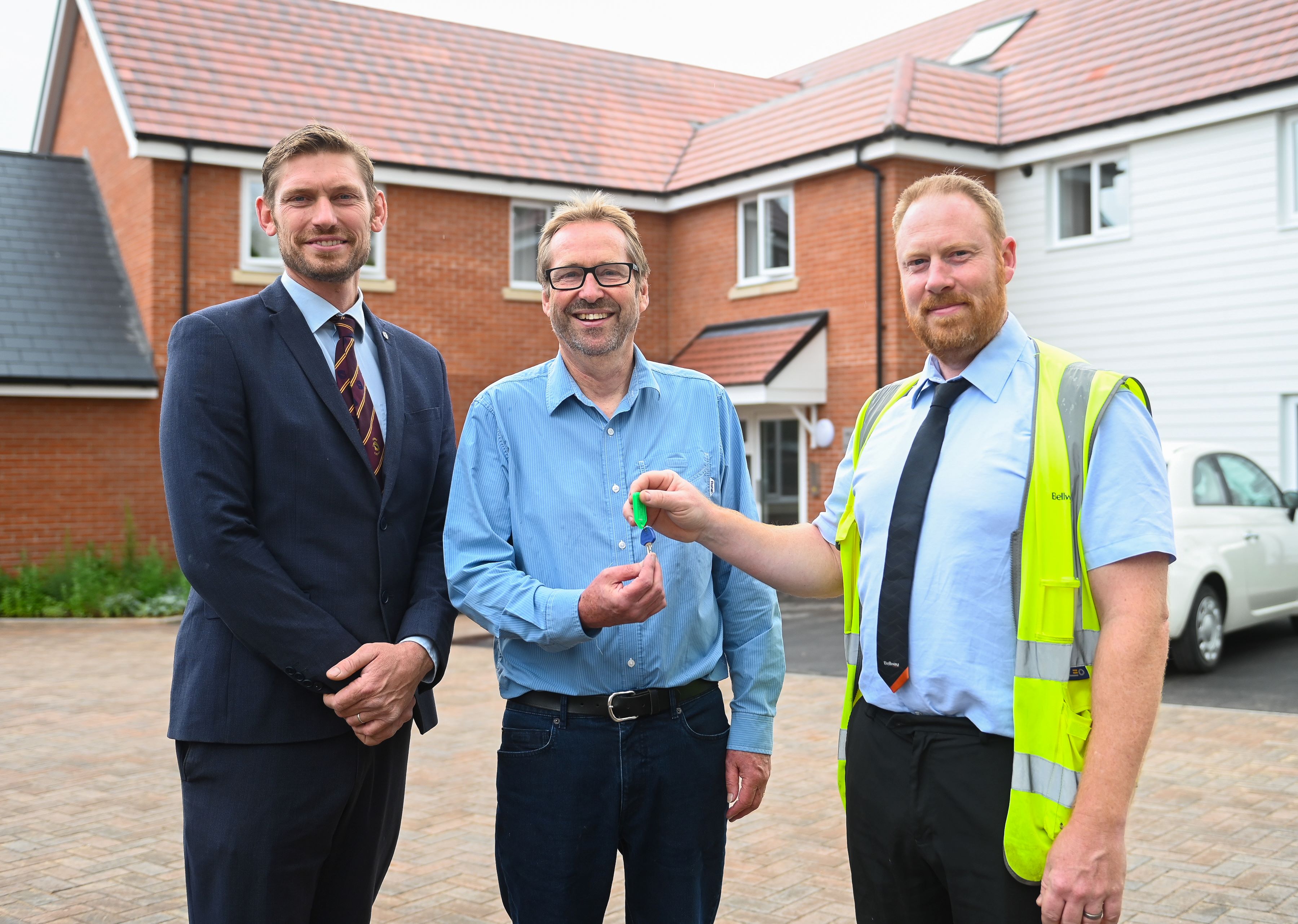 Councillor James Caston Bramford ward councillor and Cllr Richard Winch Mid Suffolk District Council cabinet member for housing and property, receive keys for the new home on Loraine Way from Matthew Dunlop, Bellway’s Construction Manager.